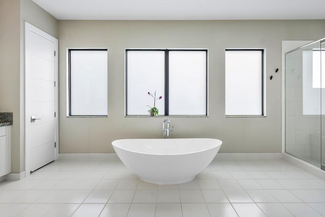 bathroom with plus walk in shower, vanity, and tile patterned floors