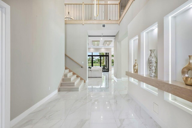 entryway featuring a towering ceiling