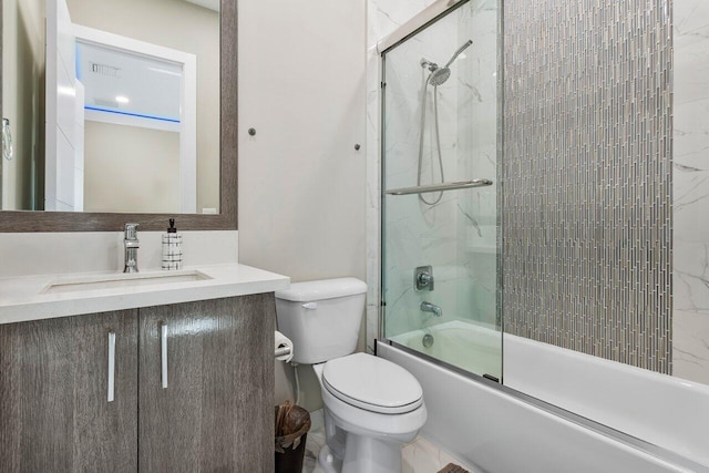 full bathroom featuring vanity, enclosed tub / shower combo, and toilet