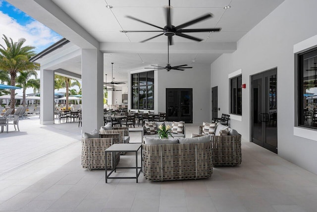 view of patio / terrace with ceiling fan and an outdoor living space