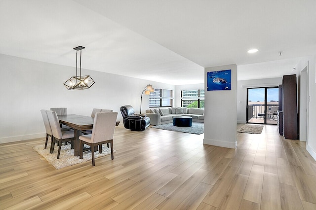 dining space featuring an inviting chandelier and light hardwood / wood-style floors