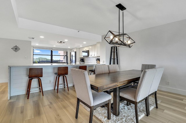 dining space featuring light wood-type flooring