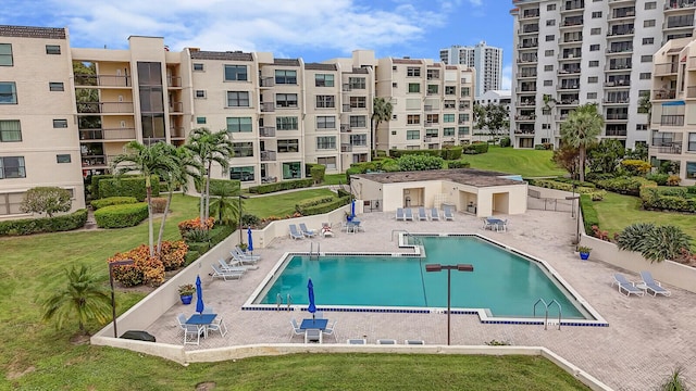 view of swimming pool featuring a yard and a patio area