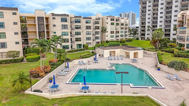 view of pool with a patio and a yard