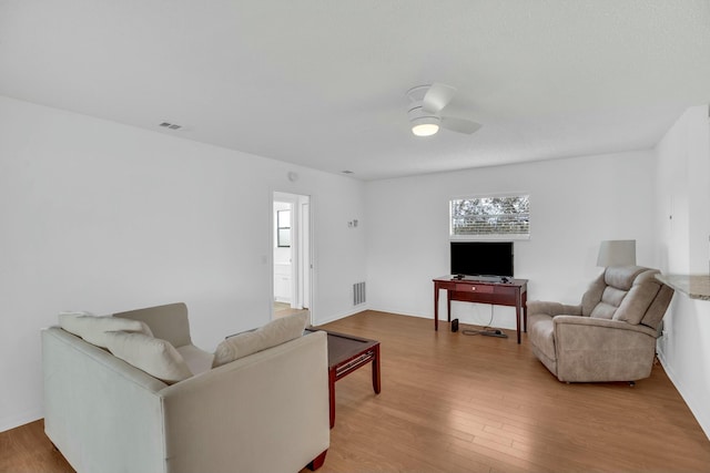 living room featuring ceiling fan and light wood-type flooring