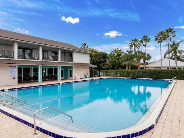 view of swimming pool featuring a patio area