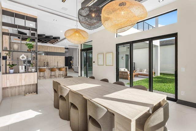 tiled dining room with a high ceiling