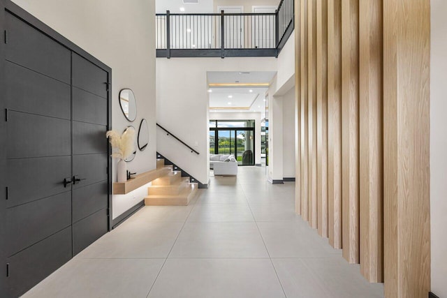 tiled foyer entrance featuring a high ceiling