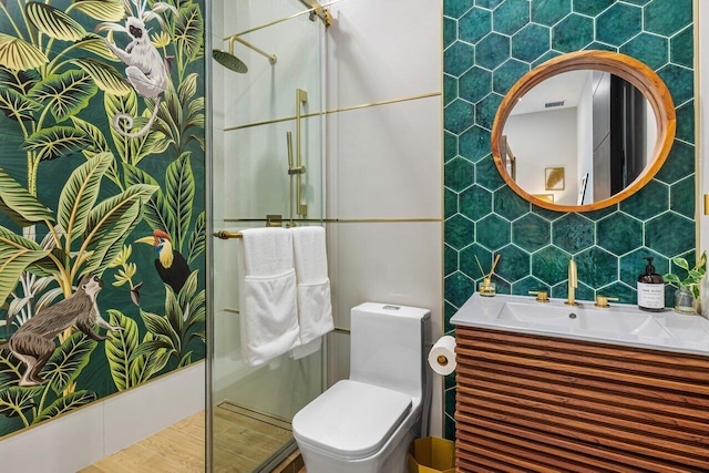 bathroom with walk in shower, tile walls, vanity, and toilet