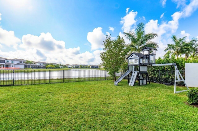 view of yard with a playground and a water view