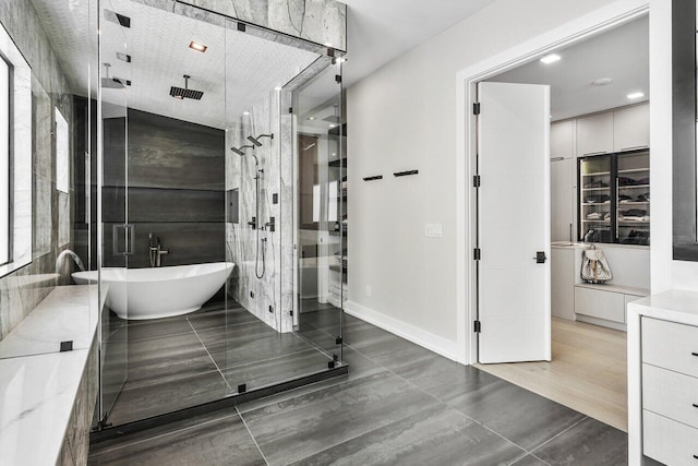 bathroom featuring vanity and separate shower and tub