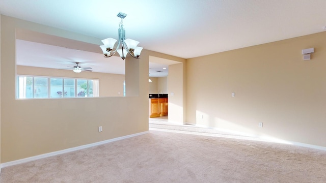 6906 NW Kowal Ct, Port Saint Lucie, FL 34986 - spare room with light carpet, a chandelier, baseboards, a ceiling fan, and a sink