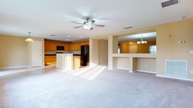 unfurnished living room with light colored carpet, visible vents, and baseboards