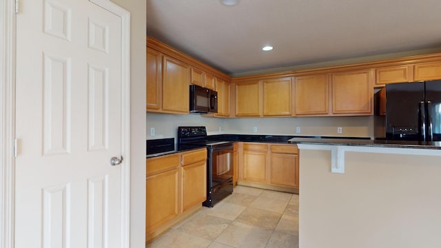 kitchen with dark countertops, black appliances, and recessed lighting