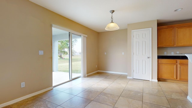6906 NW Kowal Ct, Port Saint Lucie, FL 34986 - unfurnished dining area featuring light tile patterned flooring and baseboards