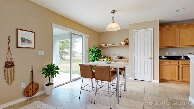 6906 NW Kowal Ct, Port Saint Lucie, FL 34986 - dining space featuring light tile patterned flooring and baseboards