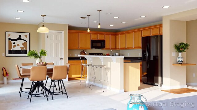 6906 NW Kowal Ct, Port Saint Lucie, FL 34986 - kitchen featuring black appliances, a kitchen breakfast bar, recessed lighting, an island with sink, and pendant lighting