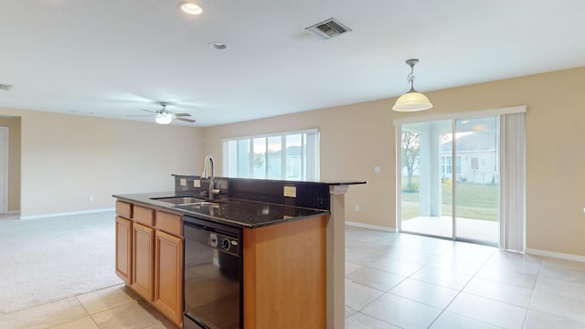 kitchen featuring visible vents, dishwasher, decorative light fixtures, a kitchen island with sink, and a sink