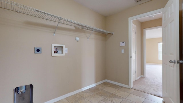 clothes washing area with laundry area, light tile patterned floors, baseboards, hookup for a washing machine, and hookup for an electric dryer