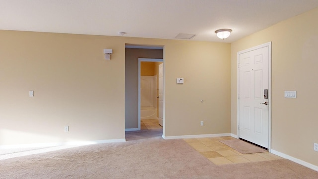 unfurnished room with light carpet and baseboards