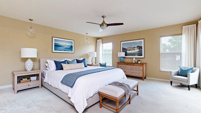6906 NW Kowal Ct, Port Saint Lucie, FL 34986 - bedroom with light colored carpet, multiple windows, baseboards, and a ceiling fan