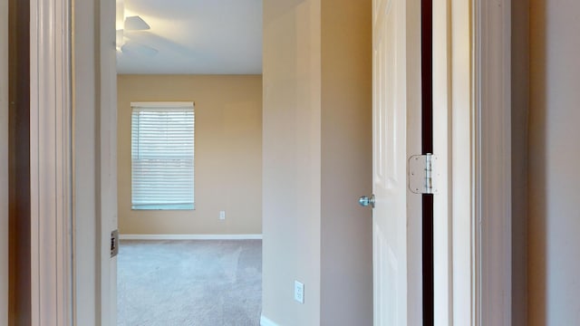 hall with light colored carpet