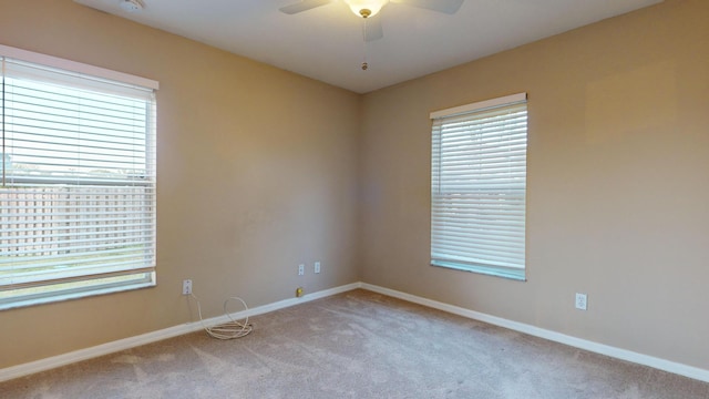 unfurnished room with light carpet, ceiling fan, and baseboards