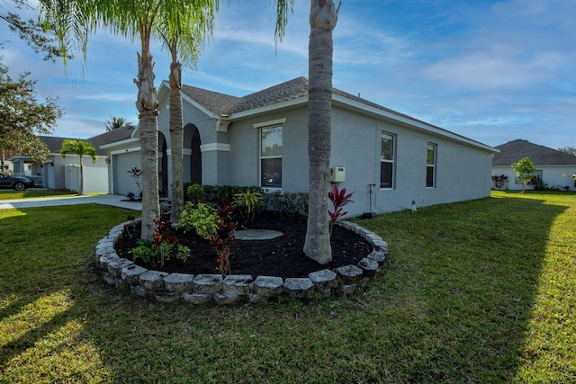 view of side of property with a garage, a yard, and stucco siding