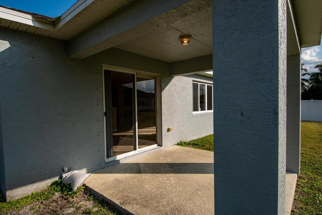 rear view of property featuring a patio and a lawn