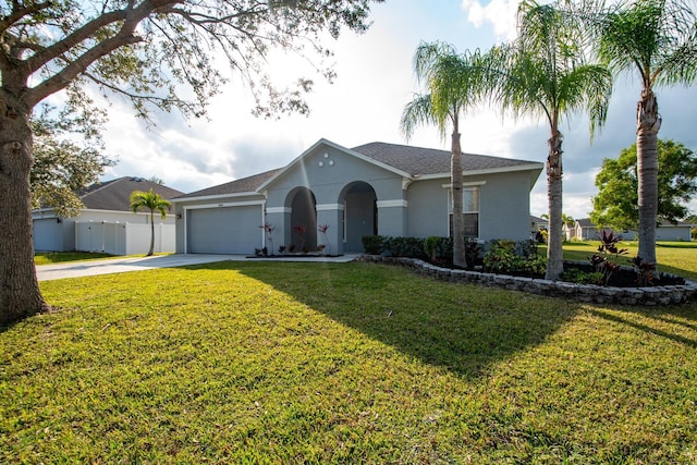 single story home featuring a garage and a front yard