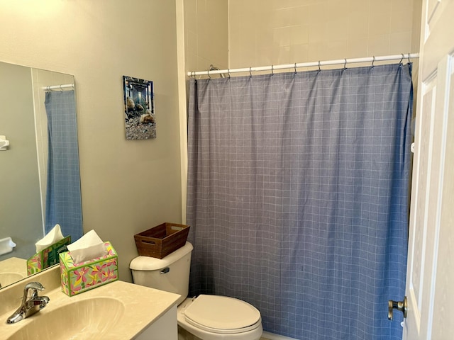 bathroom with vanity, curtained shower, and toilet