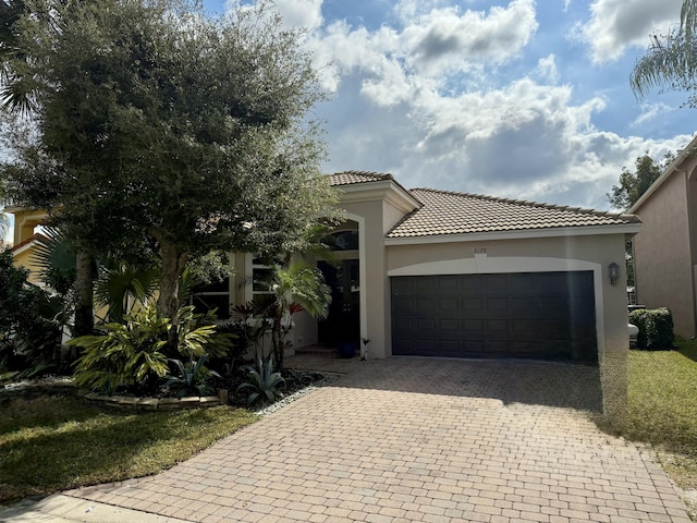 mediterranean / spanish-style home featuring a garage