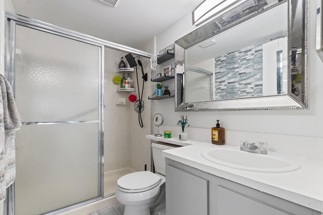 bathroom with vanity, an enclosed shower, and toilet