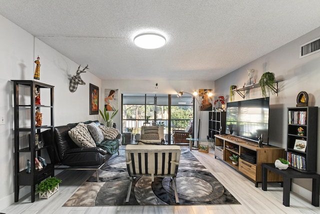 living room with hardwood / wood-style flooring and a textured ceiling