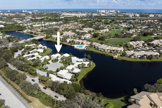 drone / aerial view featuring a residential view and a water view