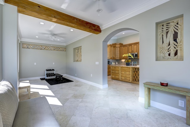 living room featuring beamed ceiling, ceiling fan, and crown molding