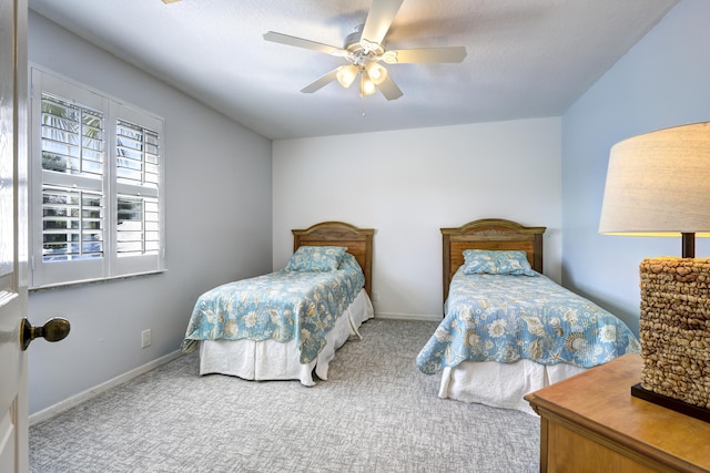 bedroom with a textured ceiling, ceiling fan, and carpet