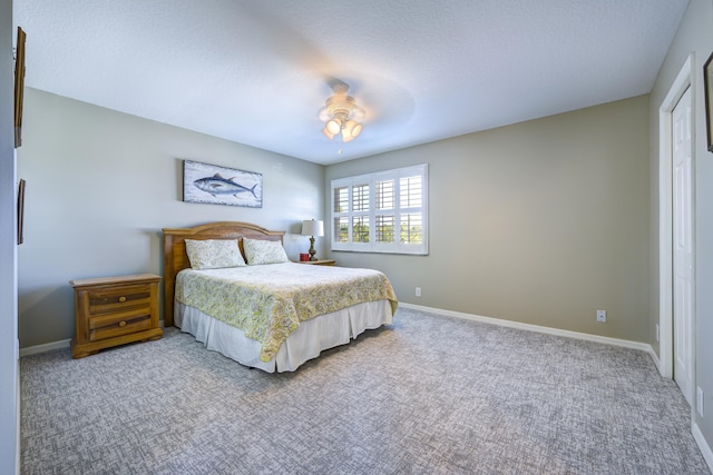 bedroom featuring ceiling fan, carpet, and a textured ceiling