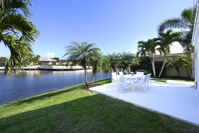 view of yard with a water view and a patio area