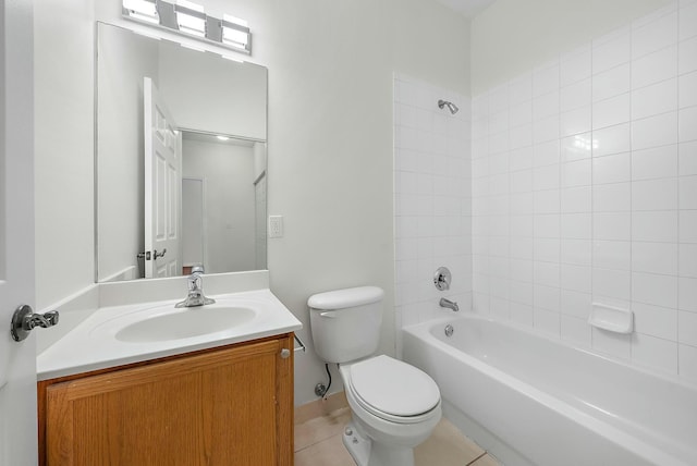 full bathroom featuring tiled shower / bath, vanity, and toilet