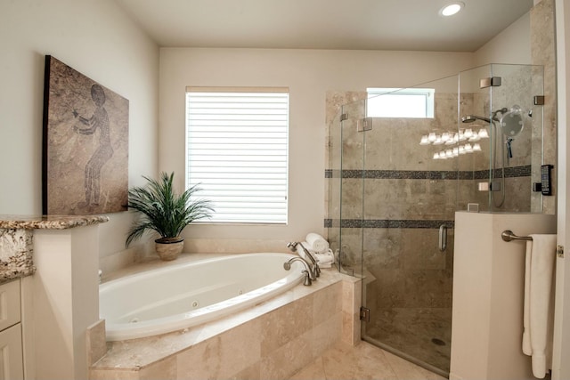 bathroom with tile patterned floors and separate shower and tub