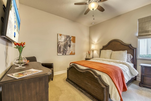 bedroom featuring ceiling fan and light carpet