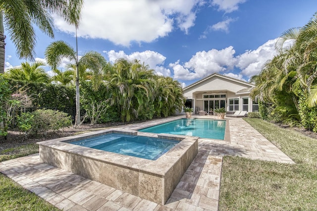 view of pool featuring an in ground hot tub and a patio