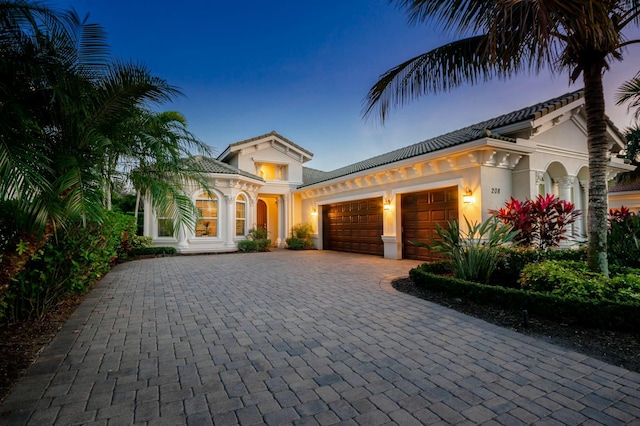 mediterranean / spanish-style house with a garage