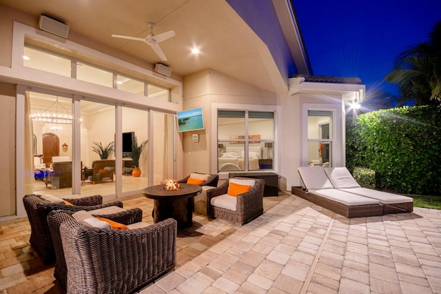 view of patio / terrace featuring an outdoor living space with a fire pit and ceiling fan