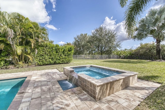 view of pool featuring a yard, a patio area, and an in ground hot tub