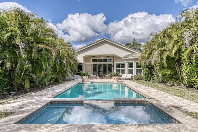 view of pool featuring a patio area and an in ground hot tub