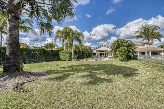 view of yard with a fenced in pool