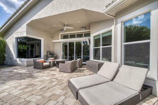 view of patio featuring an outdoor living space, grilling area, and ceiling fan