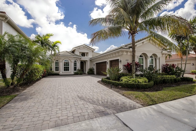 mediterranean / spanish-style house with a garage